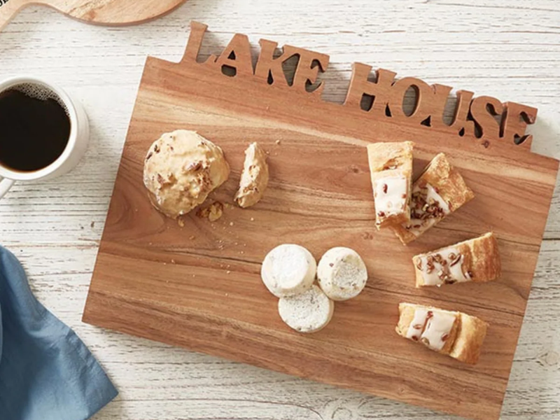 a wooden cutting board that says "lake house" from marigold gift shop